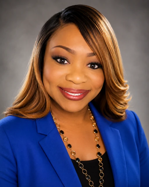 LaKeisha G. Brown, founder of The Learning Leader, smiling in a royal blue blazer